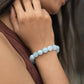 Natural aquamarine round gemstones studded stretchable bracelets on model hand