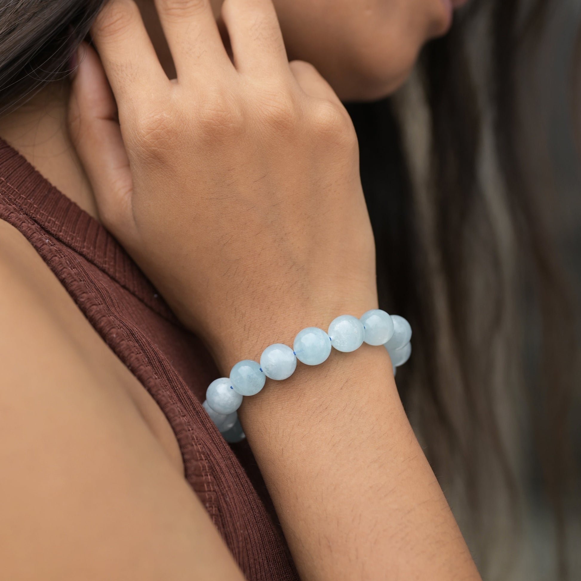 Natural aquamarine round gemstones studded stretchable bracelets on model hand