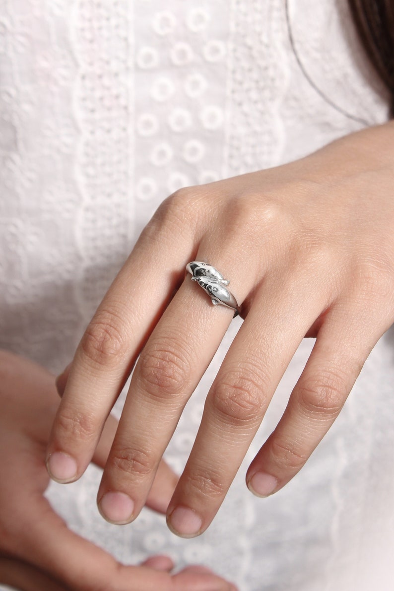 Sterling silver dolphin ring in a model's finger