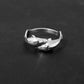 Dual dolphin design sterling silver ring on black background